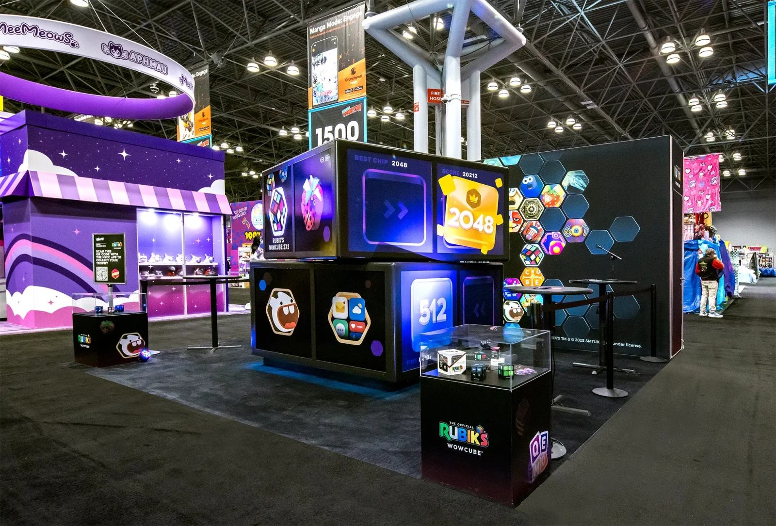 Rubik’s WowCube exhibit booth displaying interactive game screens and WowCube products at a convention