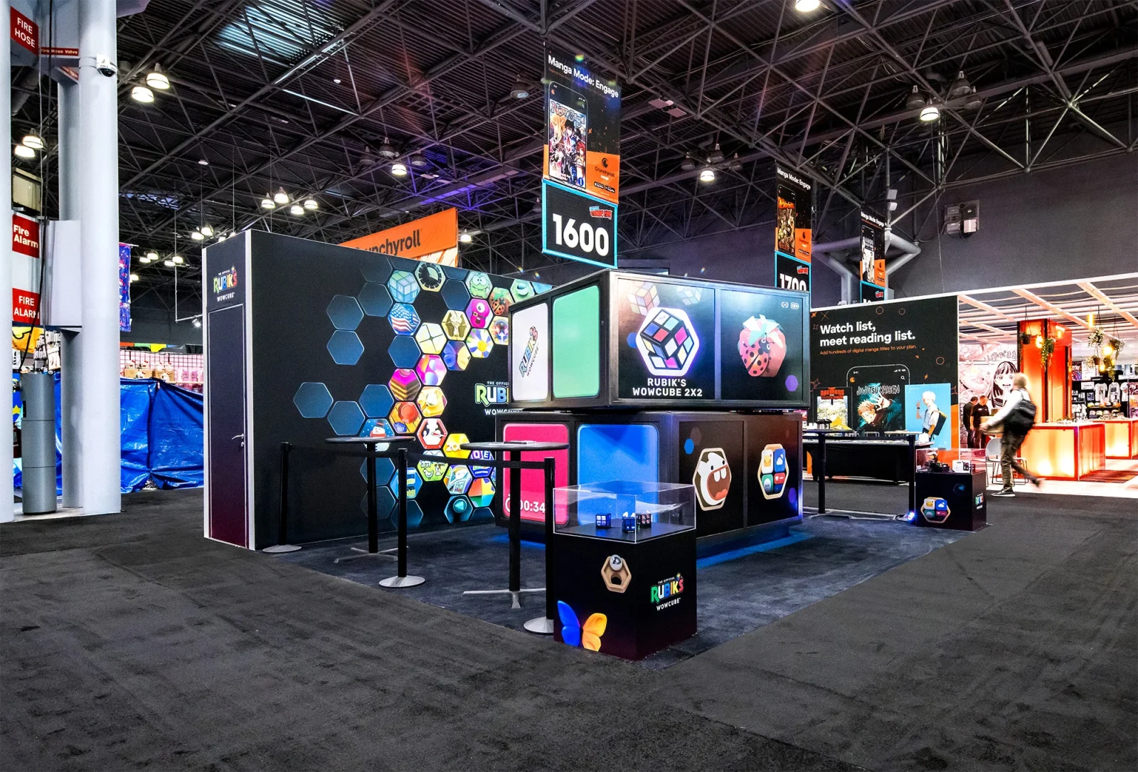 Rubik's WowCube exhibition booth displaying colorful cube products, screens, and promotional graphics