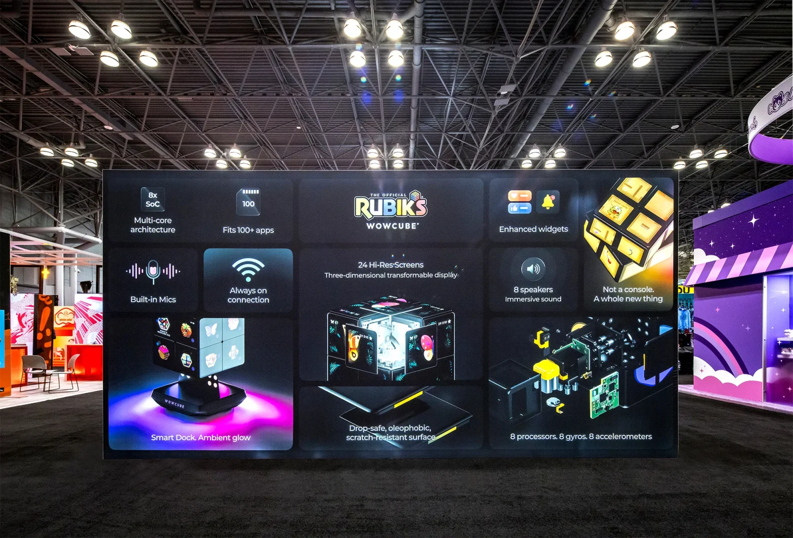 Trade show display promoting the Rubik’s WowCube, with product images and feature panels for its screens, speakers, microphones, and sensors.