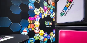 Rubik's WowCube trade show booth featuring colorful hexagonal game icons and the WowCube logo