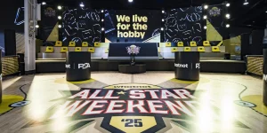 Whatnot All-Star Weekend ’25 display area with a court-style floor, PSA-branded podiums, and “We live for the hobby” signage.