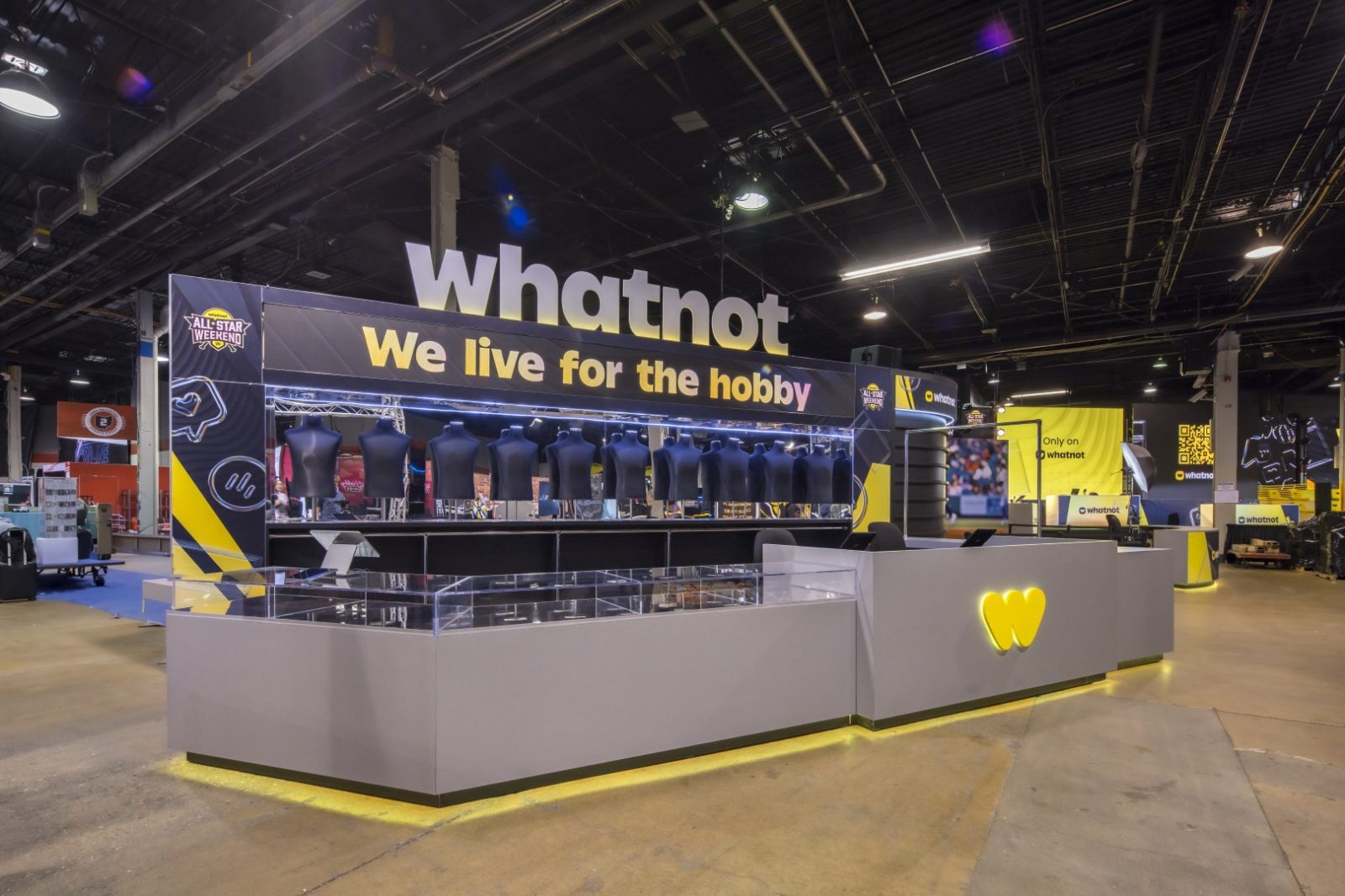 Whatnot trade show booth with jewelry display busts, counters, and the slogan “We live for the hobby.”