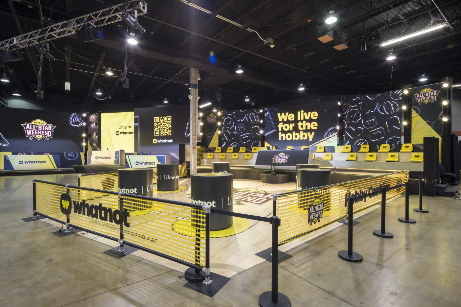 Whatnot All-Star Weekend event space with a branded court, seating, and large “We live for the hobby” backdrop