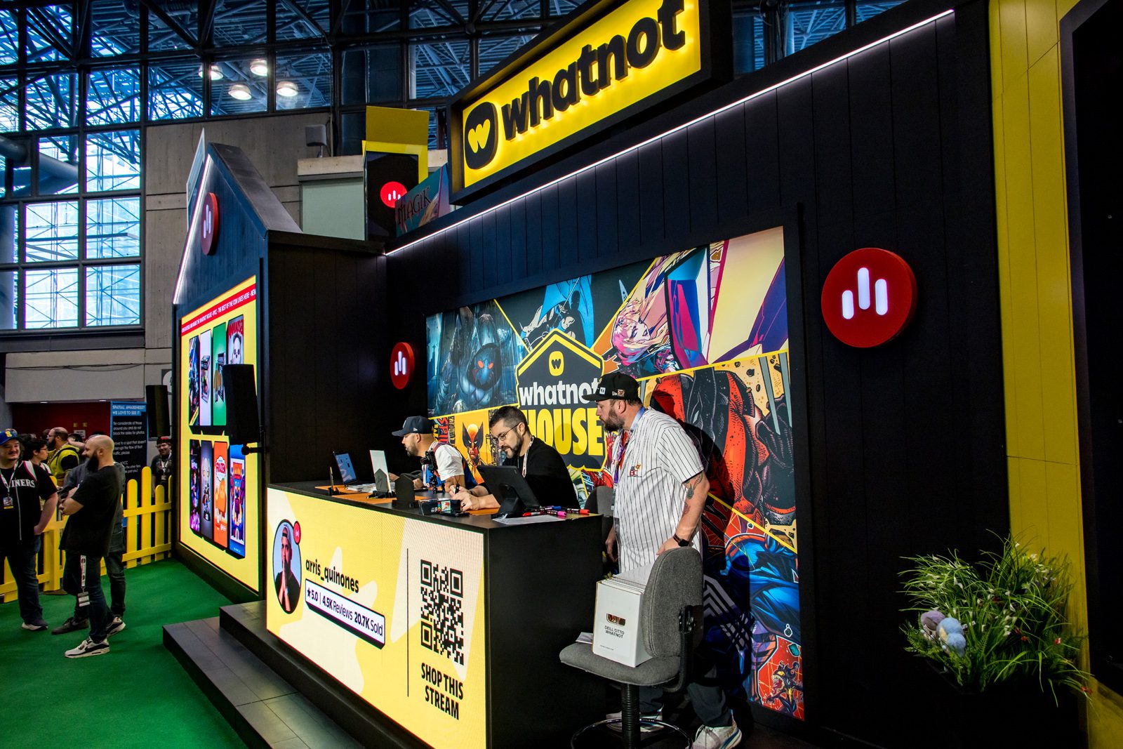 Whatnot booth with branded signage, comic-style graphics, a live-streaming counter, and staff at a trade show