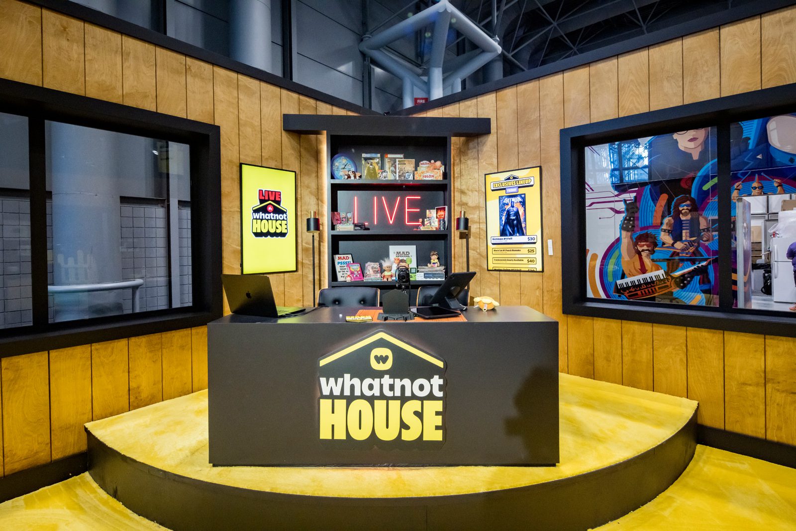 Whatnot House live booth with branded reception desk, product displays, and colorful wall mural