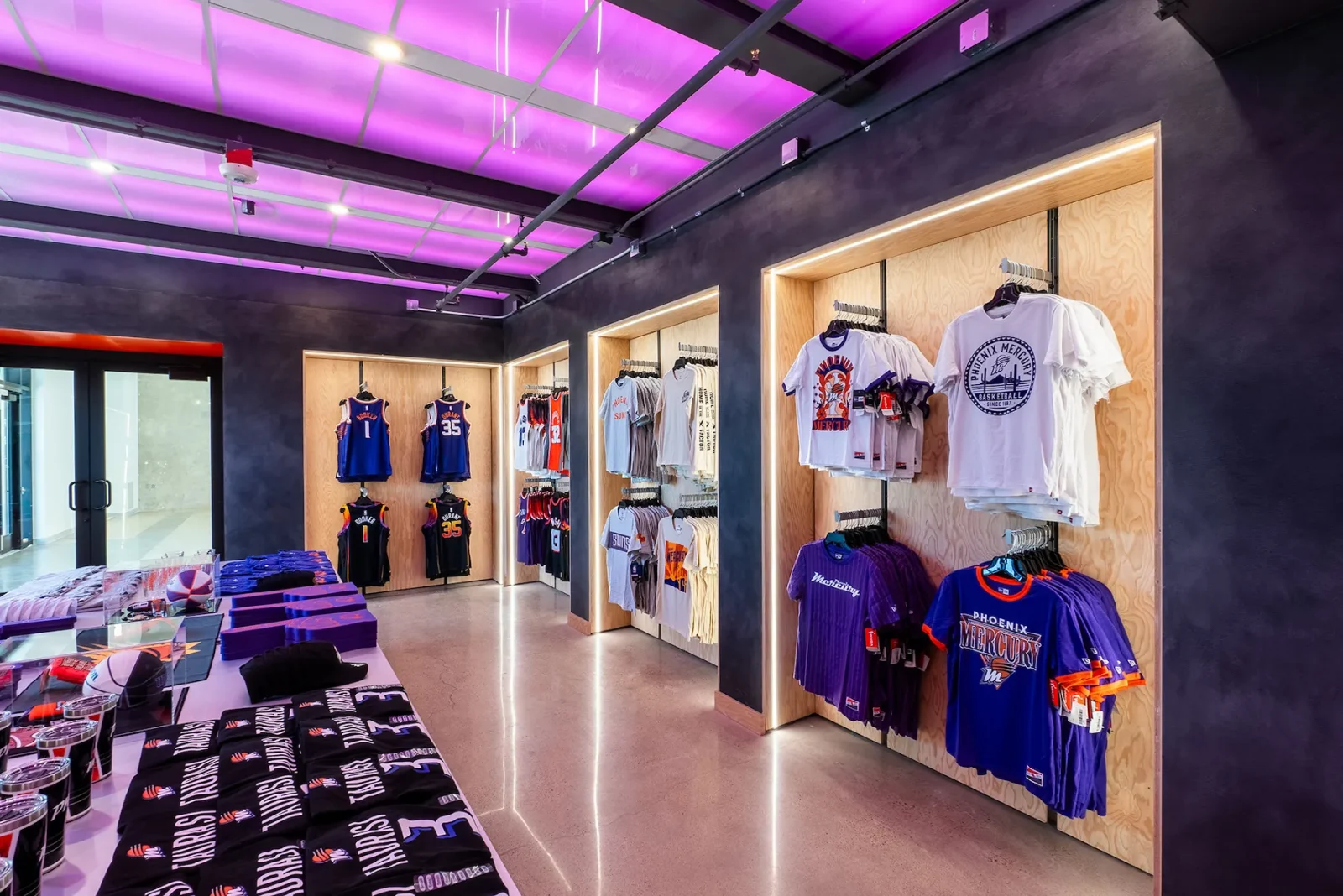 Phoenix Mercury team store displaying basketball jerseys, T-shirts, scarves, and merchandise.
