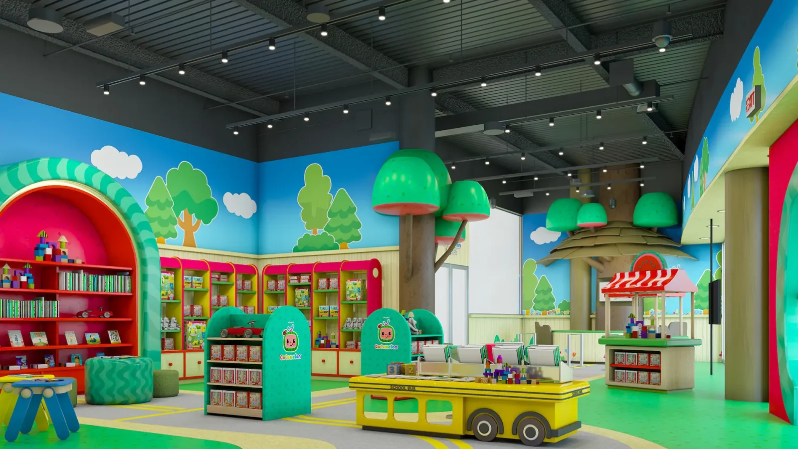 Colorful CoComelon-themed indoor play space with toy shelves, a school bus table, mushroom-shaped trees, and a market stall.