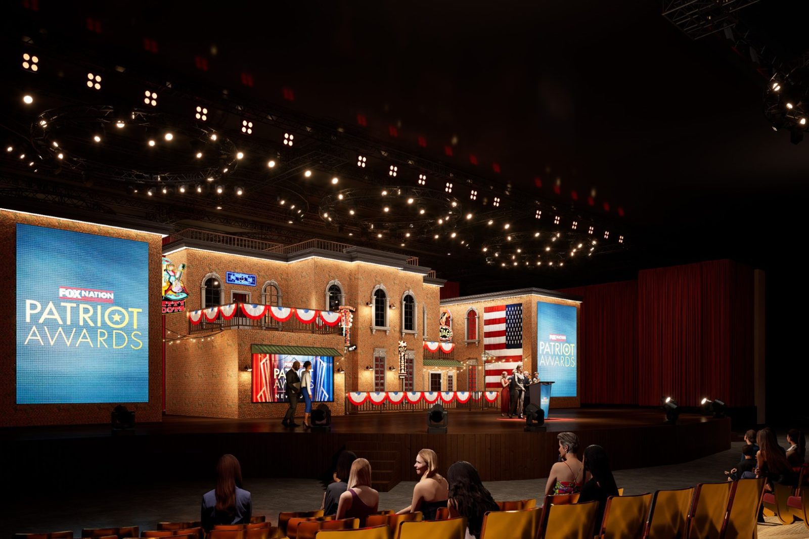 Stage set for the FOX Nation Patriot Awards, with presenters and an audience in a theater.