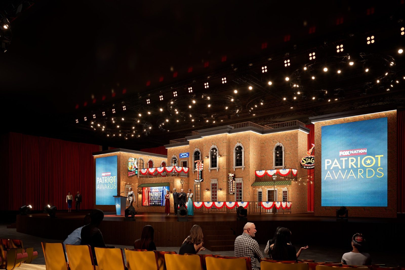 Stage set for the Patriot Awards with brick façades, patriotic bunting, event screens, and seated audience
