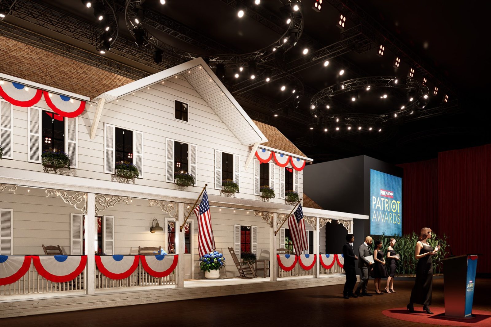 Patriot Awards stage featuring a house-front set decorated with American flags and people gathered near a podium.