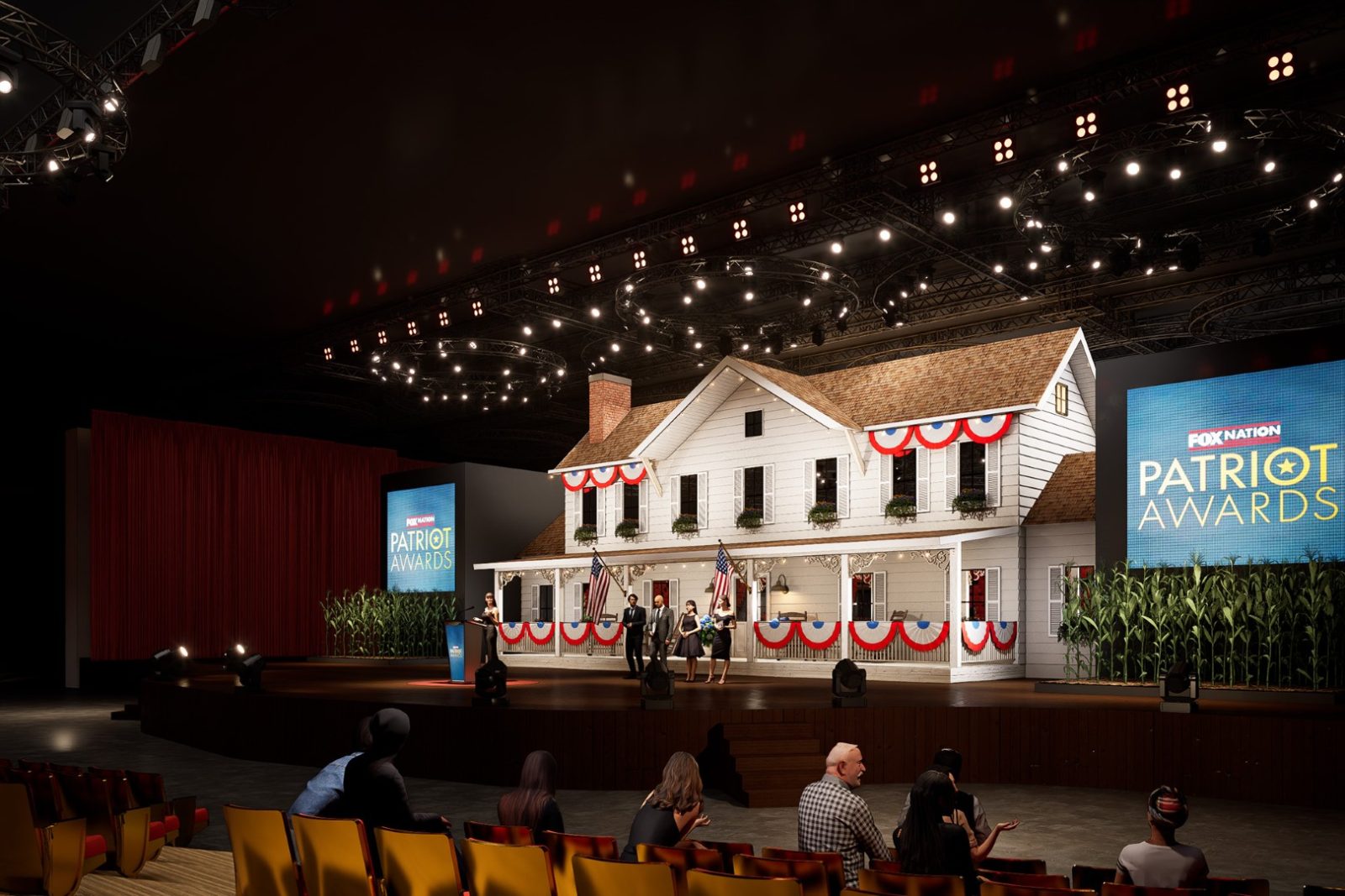 Stage set with a white house facade, American flags, patriotic bunting, corn stalks, and screens reading “Fox Nation Patriot Awards.”