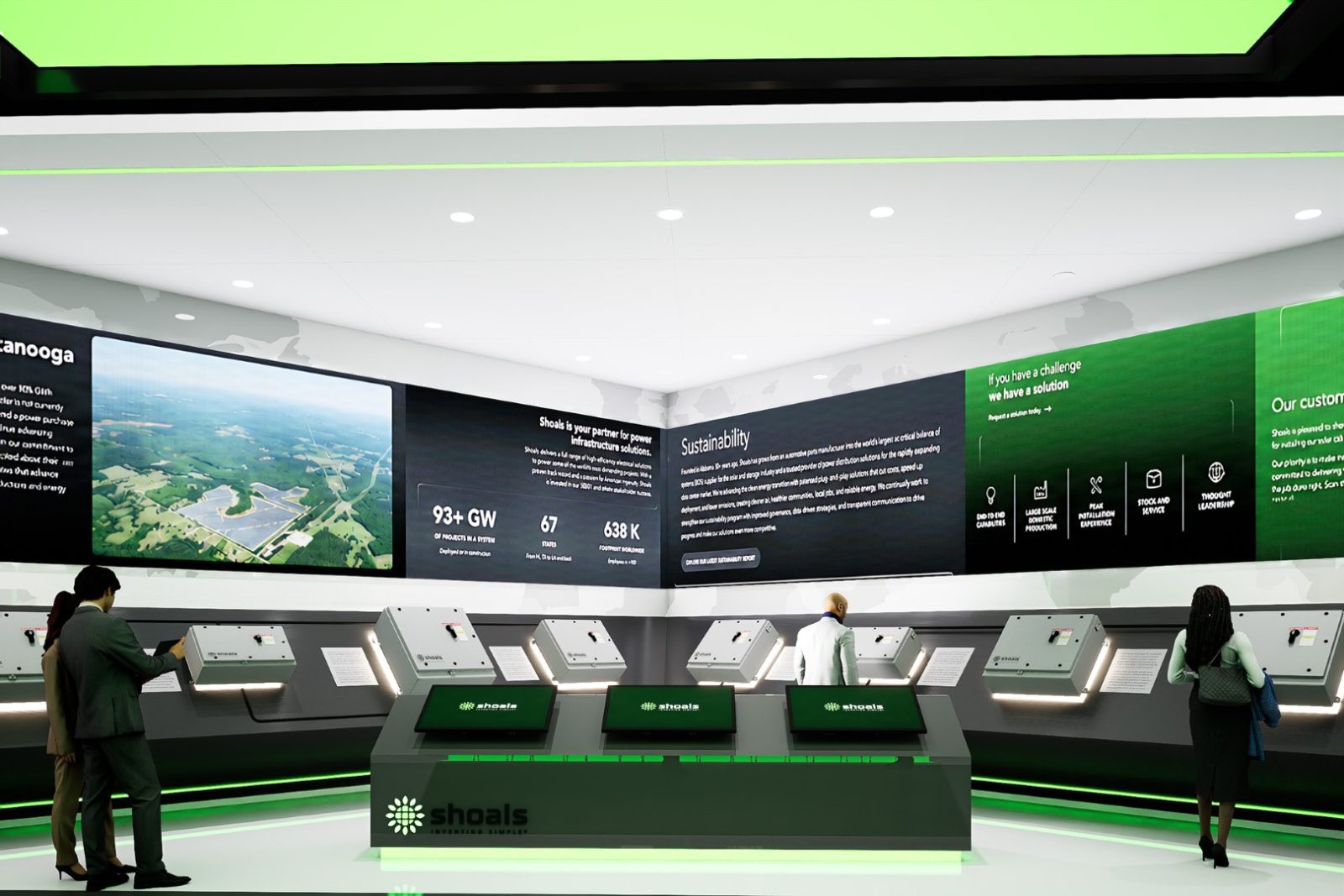Shoals exhibition display featuring interactive panels, sustainability information, and an aerial view of an industrial site.