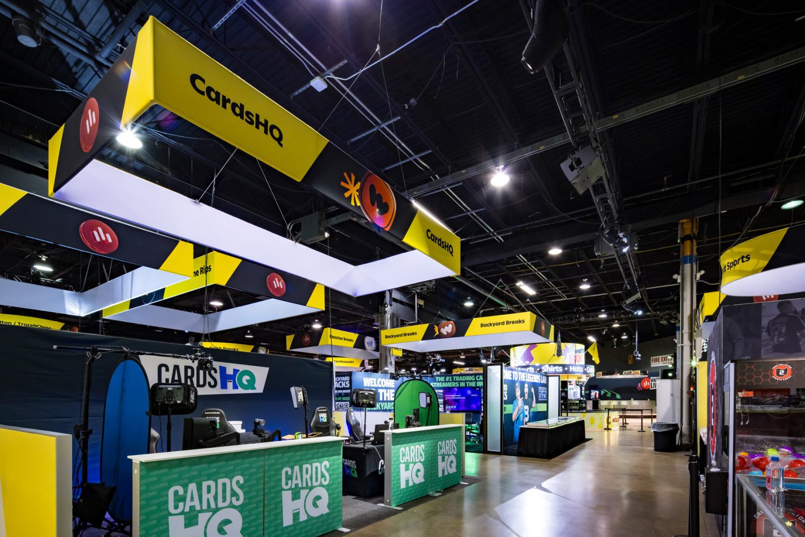 Cards HQ trading card booth inside a convention hall, with CarasHQ overhead signage and display counters.