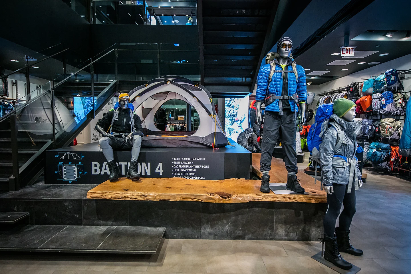 Outdoor retail display featuring a Baffin 4 tent, hiking mannequins, and backpacks.