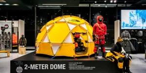 The North Face store display featuring a yellow 2-METER DOME tent, mountaineering mannequins, and outdoor gear.