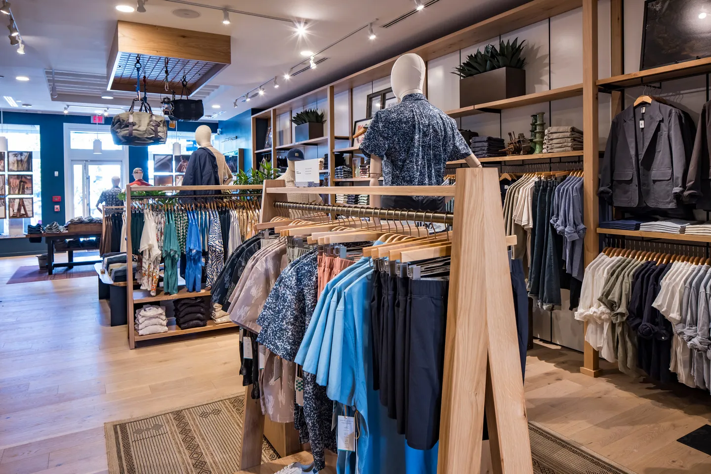 Interior of a Huckberry retail store with clothing racks, mannequins, shelves, and outdoor gear displays.