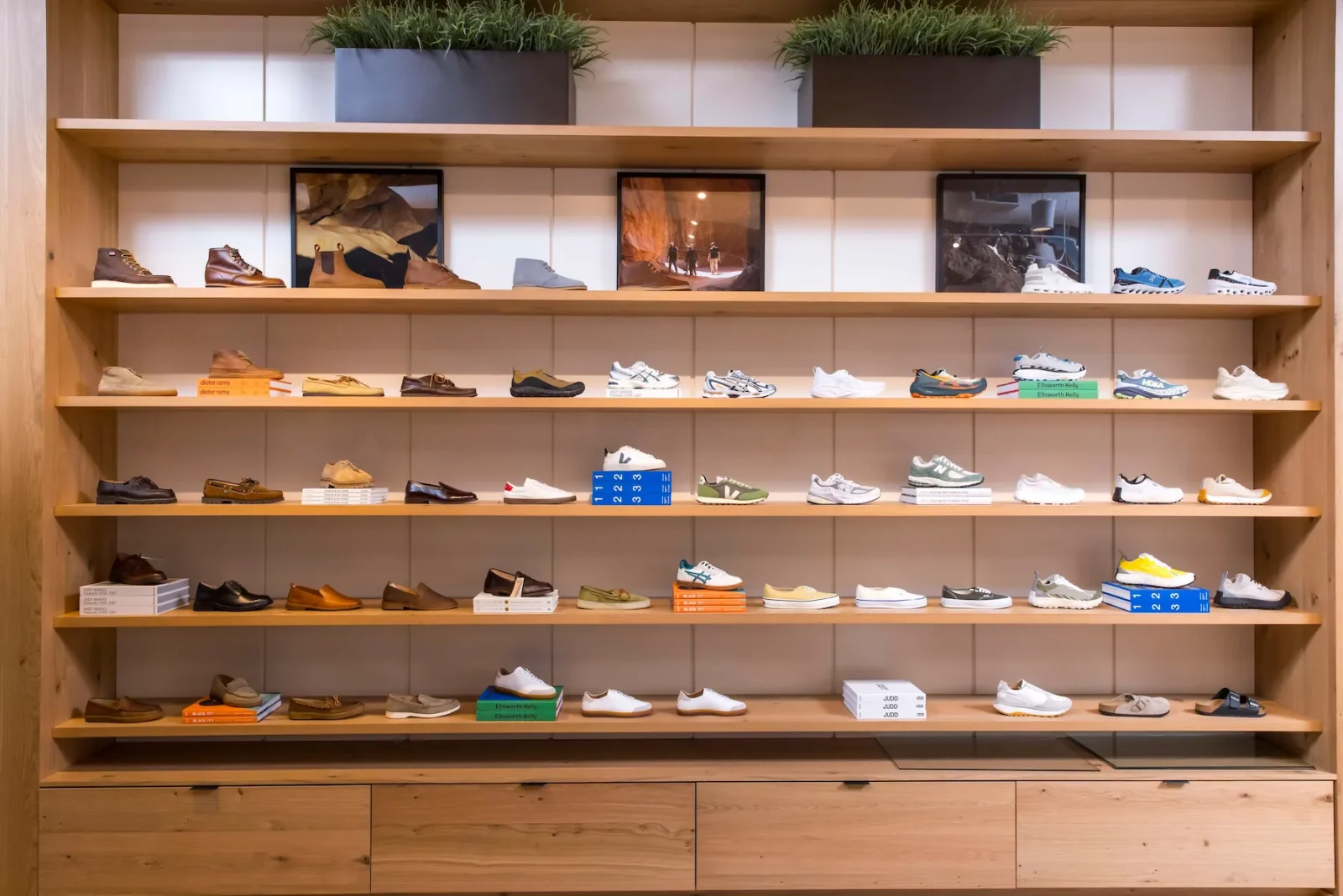 Shelves displaying a wide range of boots, sneakers, loafers, and sandals in a retail store