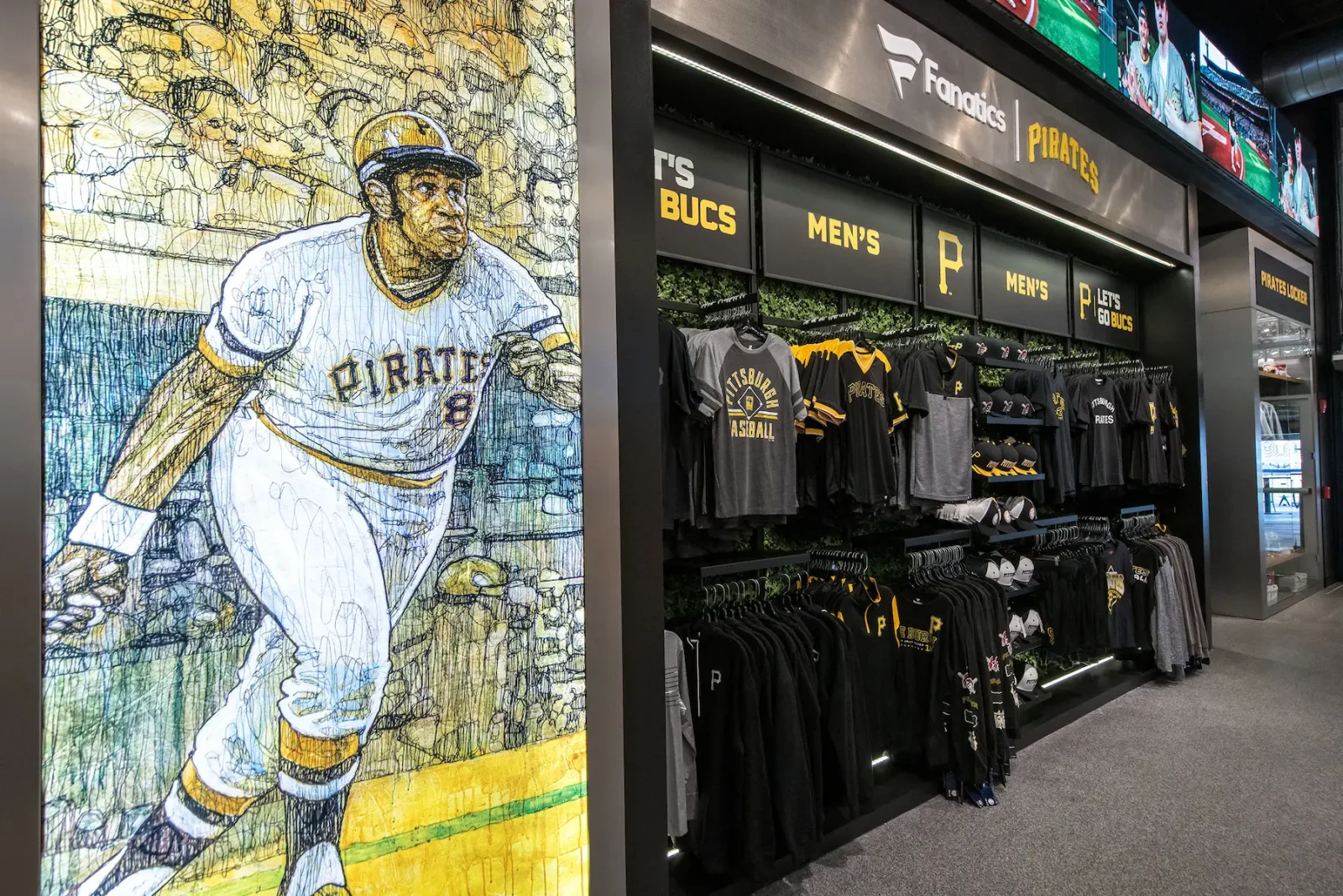 Pittsburgh Pirates team store displaying apparel beside a large illustrated baseball player mural