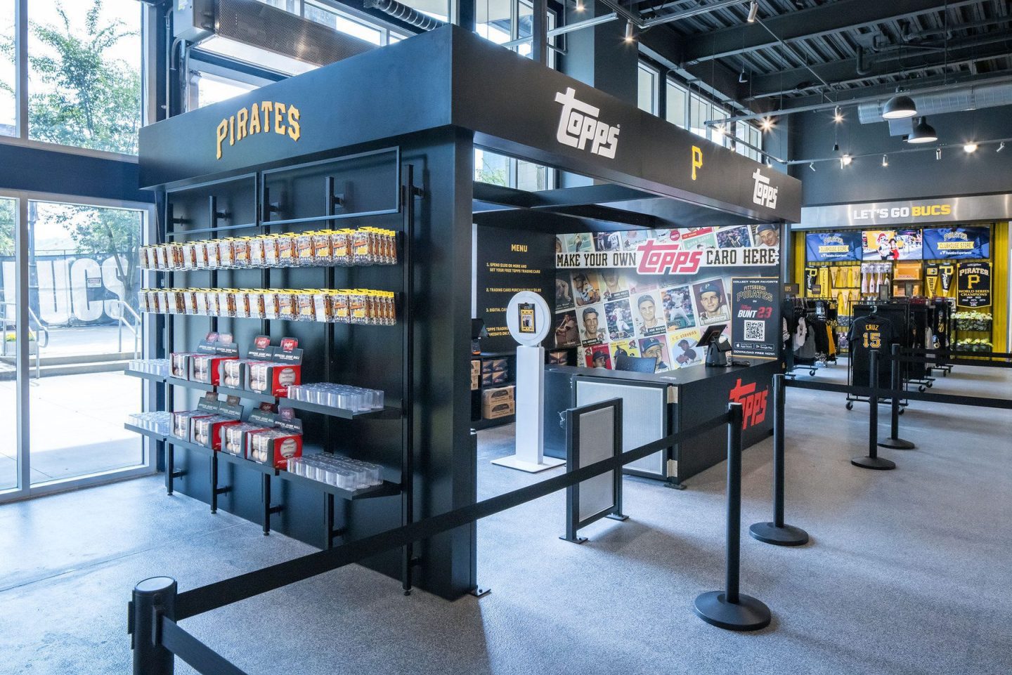 Interior of a Pittsburgh Pirates and Topps card store with trading cards, merchandise, and a custom card-making station