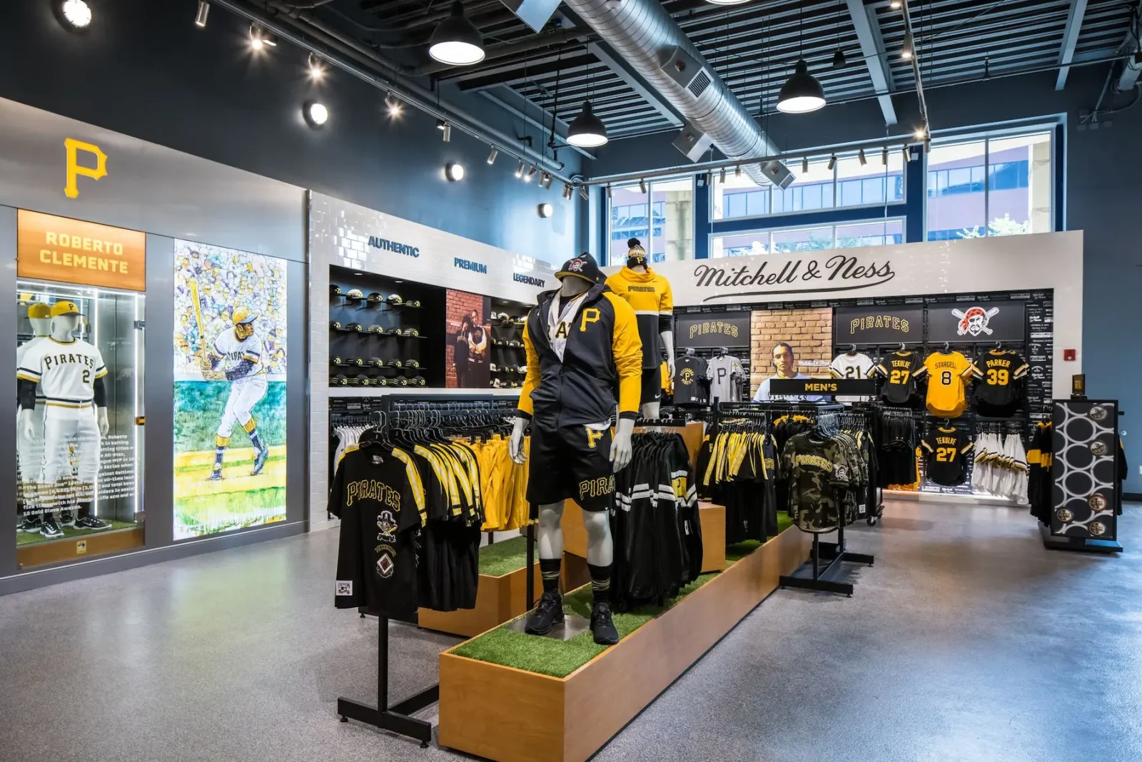Interior of a Pittsburgh Pirates team store with mannequins, jerseys, hats, and memorabilia on display.