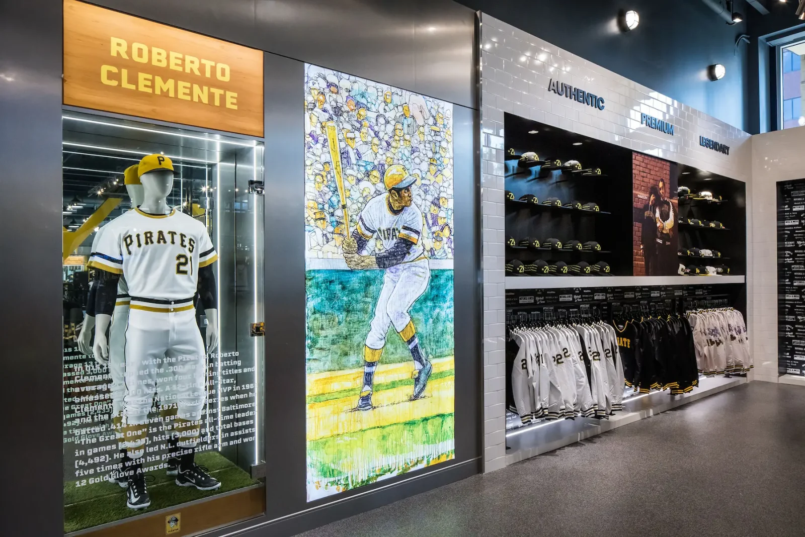 Pittsburgh Pirates store display featuring a Roberto Clemente mannequin, baseball artwork, hats, jerseys, and team memorabilia.