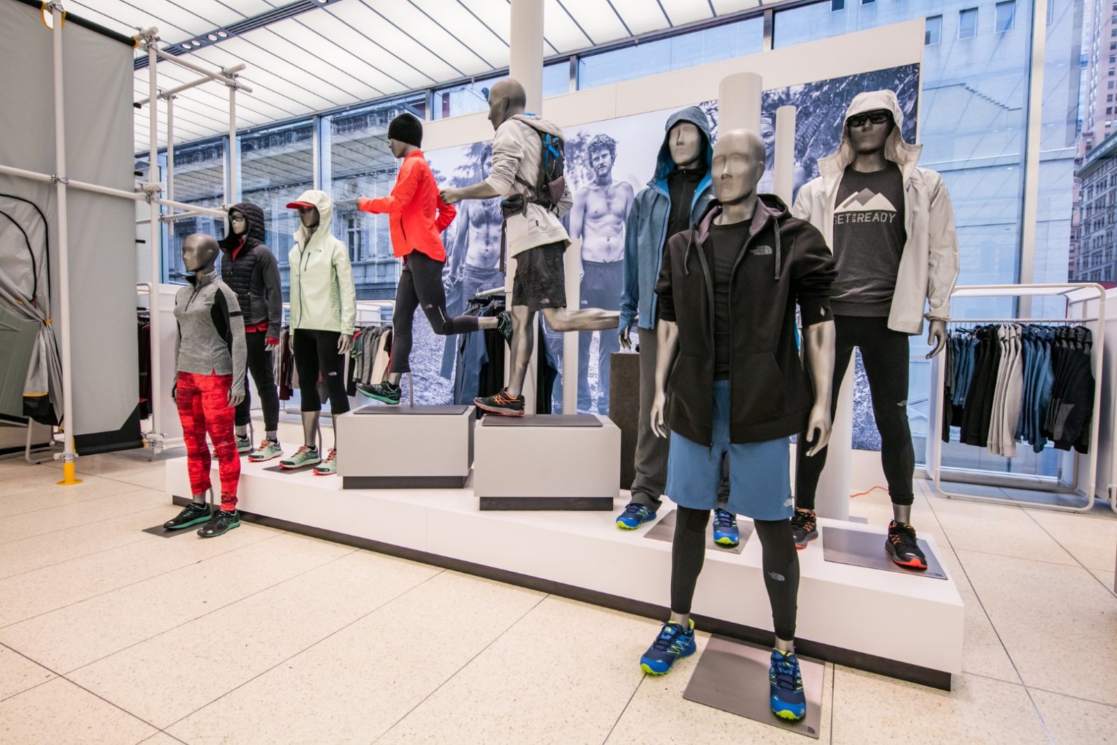 Mannequins display The North Face outdoor clothing and footwear inside a retail store.