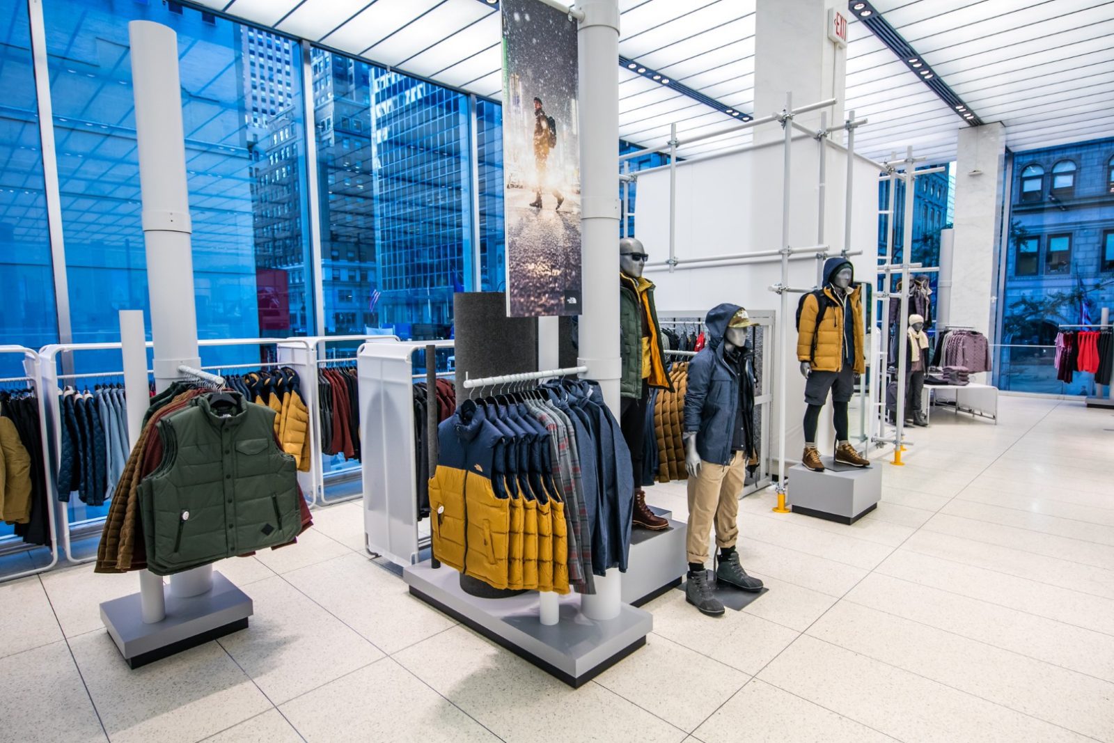Interior of a North Face store displaying outdoor jackets and clothing on racks and mannequins.