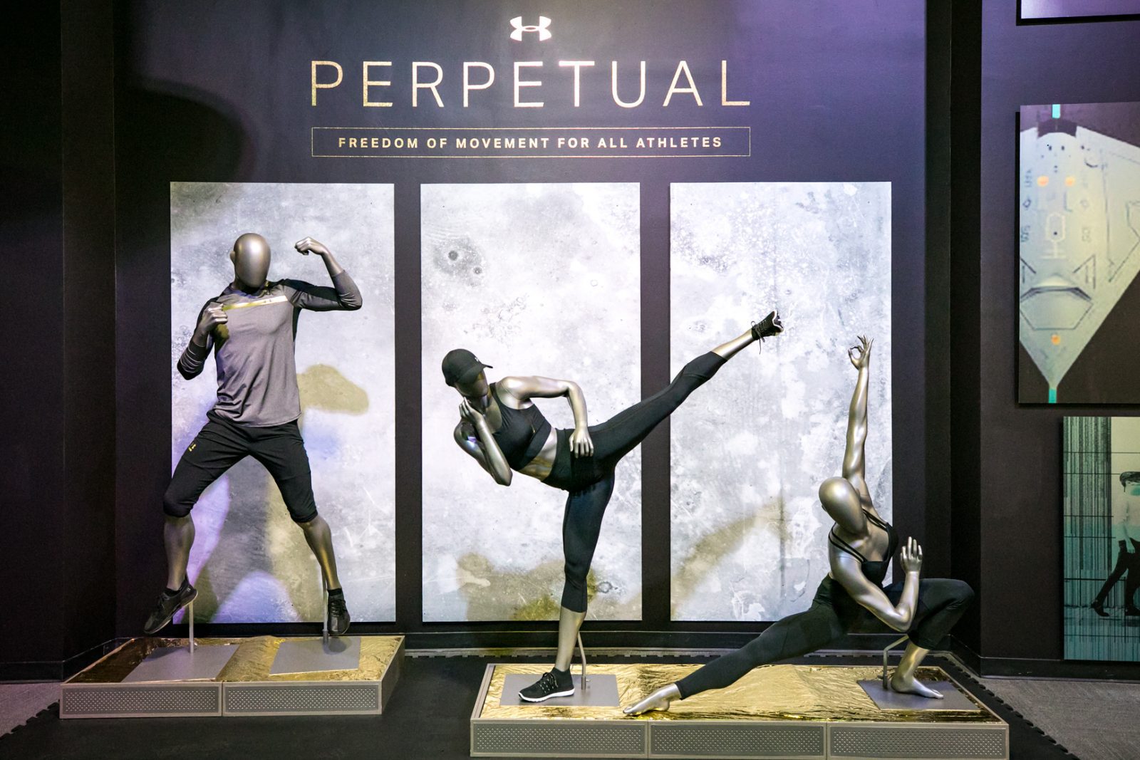 Under Armour display featuring three athletic mannequins and the slogan “PERPETUAL: FREEDOM OF MOVEMENT FOR ALL ATHLETES.”