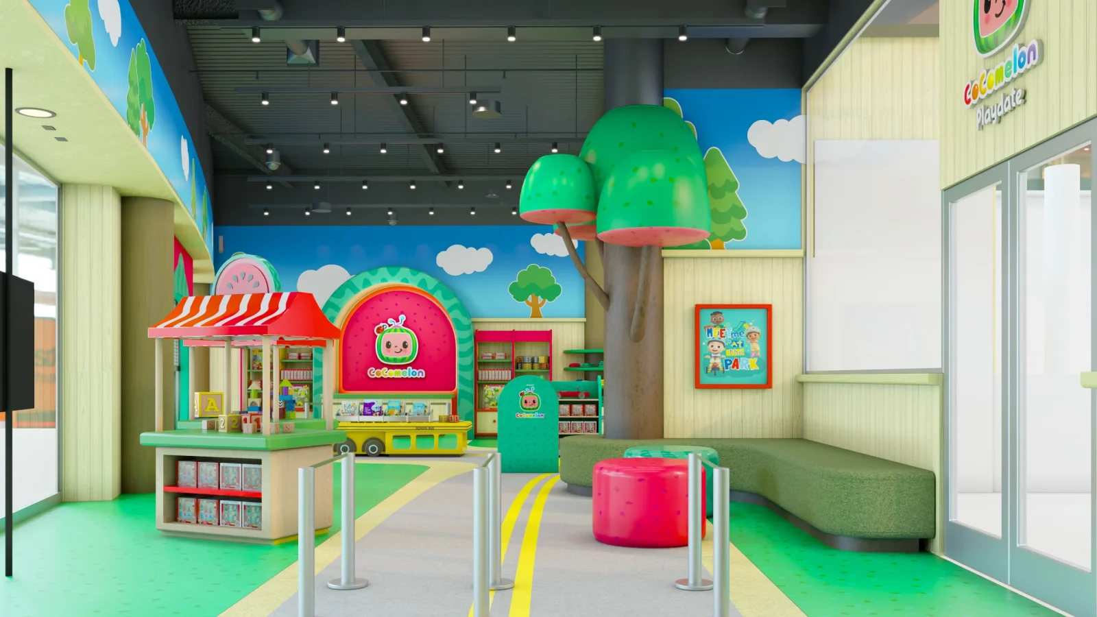 Colorful Cocomelon-themed children's play area with a toy kiosk, seating, oversized tree, and signs reading “Cocomelon Playdate” and “Meet Me at the Park.”