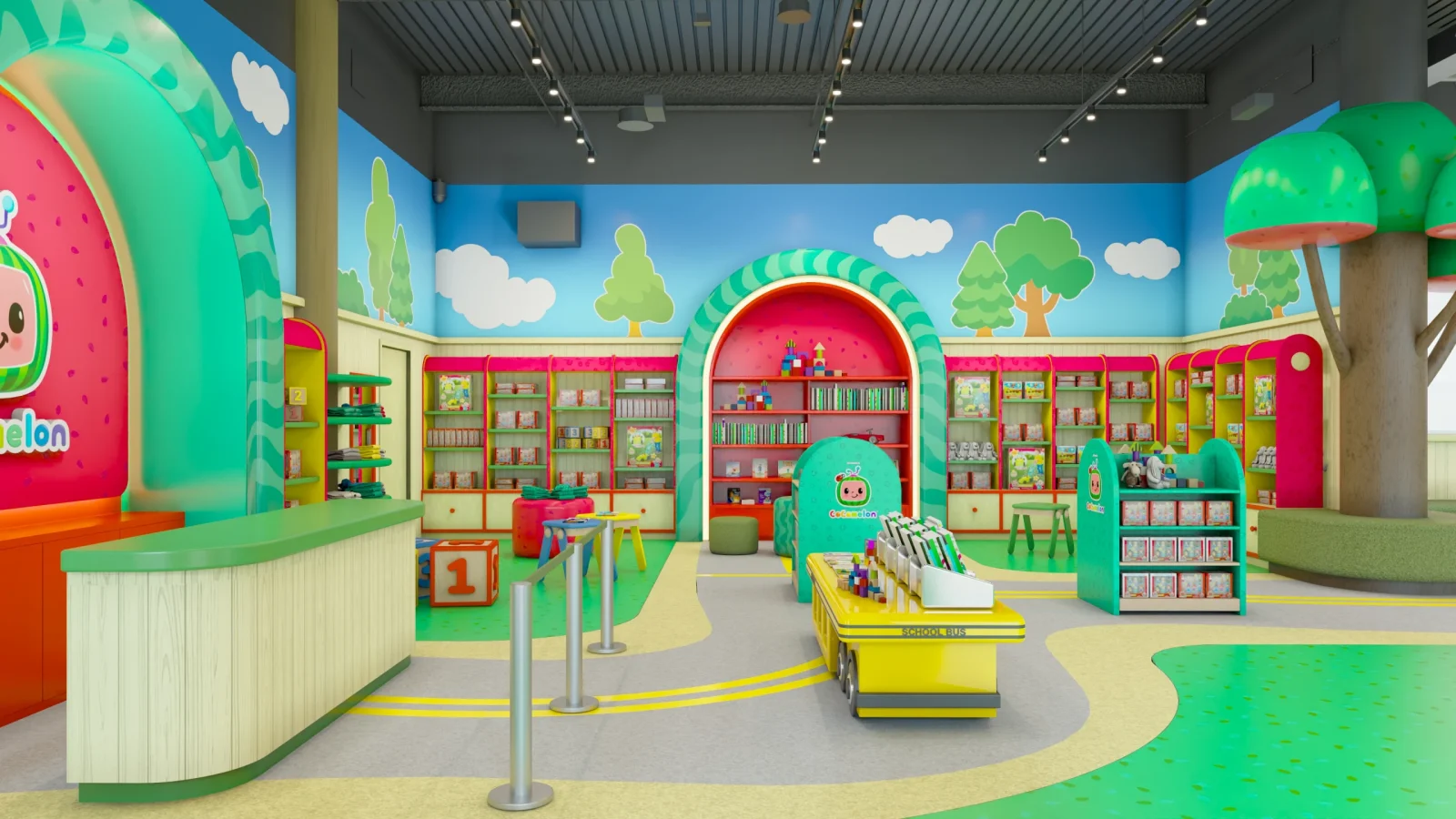 Colorful CoComelon-themed children's library with bookshelves, reading areas, a school-bus display, and playful tree and cloud murals.