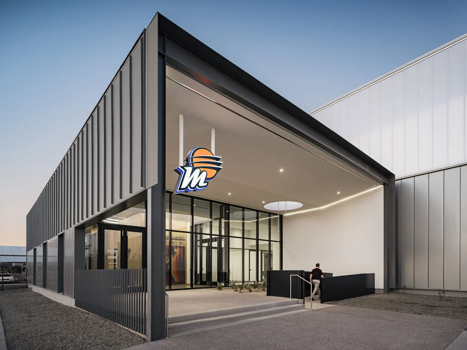 Modern Mercury building entrance with a prominent orange-and-blue Mercury logo above the glass doors.